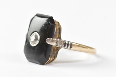 Lot 983 - A yellow metal ring, set with an onyx and...