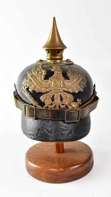 Lot 627 - A WWI Prussian M1915 pickelhaube on stand (af).