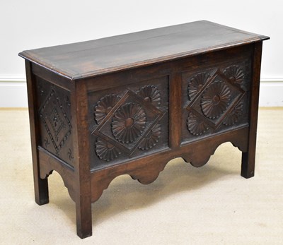 Lot 11 - A carved oak coffer with lozenge and floral...