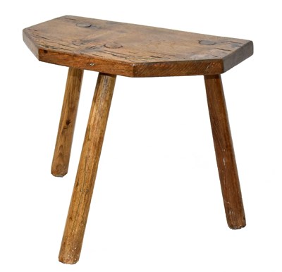 Lot 1565 - A 19th century elm top milking stool, width 36cm.