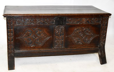 Lot 1691 - An 18th century carved oak coffer, with carved...
