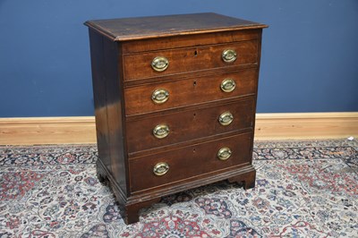 Lot 7 - A late George III oak chest, with four...