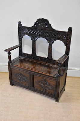 Lot 43 - An early 20th century carved oak hall settle,...