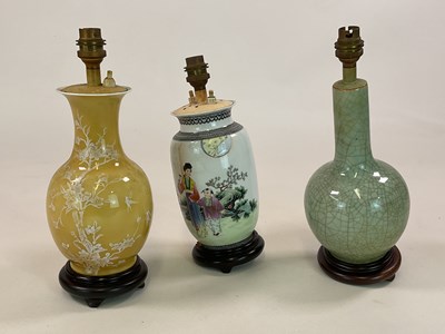 Lot 569 - Three Oriental lampbases comprising a celadon...