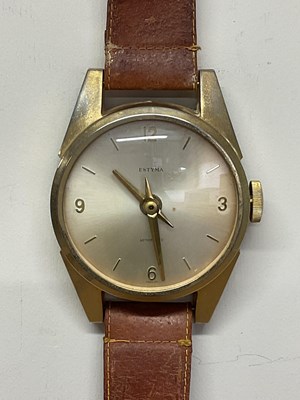 Lot 535 - ESTYMA; a wall clock styled as a wristwatch on...