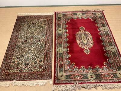 Lot 595 - Two vintage Eastern rugs, one a dark red rug...