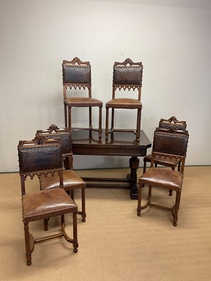 Lot 644 - An extending oak dining table with carved...