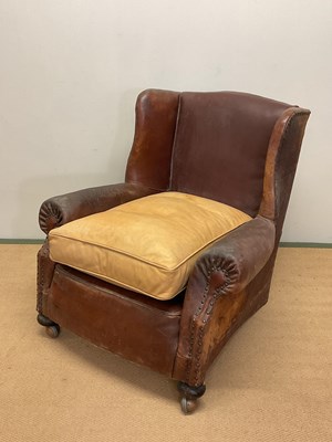 Lot 665 - An early 20th century leather armchair with...