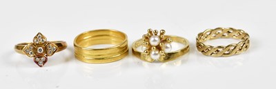 Lot 2411 - A 9ct yellow gold dress ring set with four...