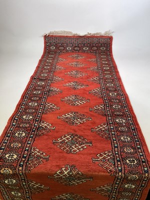 Lot 593 - A Bokhara hand knotted runner with repeating...