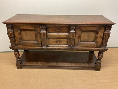Lot 650 - A carved oak sideboard, with two central...