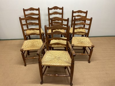 Lot 687 - Six ladder back rush seated dining chairs and...