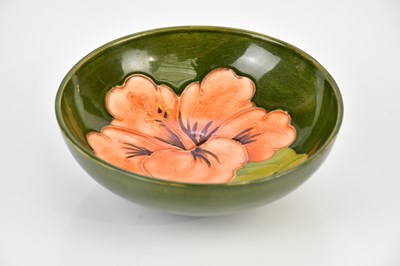 Lot 2344 - MOORCROFT; a footed bowl decorated in the...