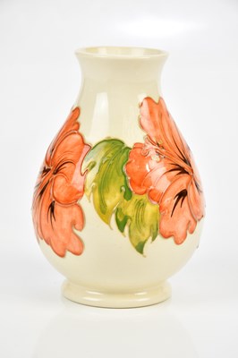 Lot 2345 - MOORCROFT; a baluster shaped vase decorated in...