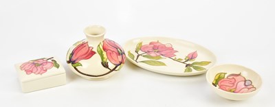 Lot 2282 - MOORCROFT; four pieces decorated in the...
