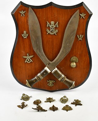 Lot 2567 - Two Gurka kukri knives mounted onto a shield...