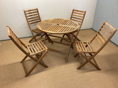 Lot 621 - A wooden garden table, diameter 90cm, and four...