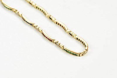 Lot 420 - A 9ct yellow gold diamond, sapphire, emerald...