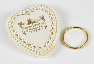 Lot 2408 - A 22ct yellow gold wedding band, size N,...