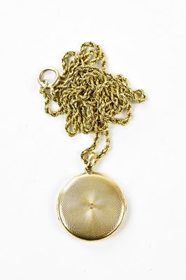 Lot 2456 - A 15ct yellow gold locket with engine turned...