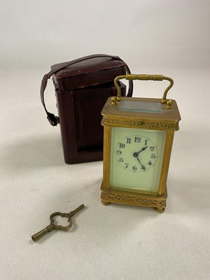 Lot 669 - A brass carriage clock with pierced decoration...