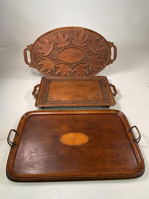 Lot 682 - Three trays comprising a carved tray decorated...