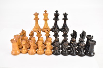 Lot 668 - A black and brown carved boxwood chess set,...