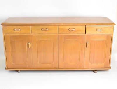 Lot 11 - PRIORY; a four-drawer, four-cupboard...