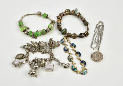 Lot 510 - PANDORA; a charm bracelet and charms, together...