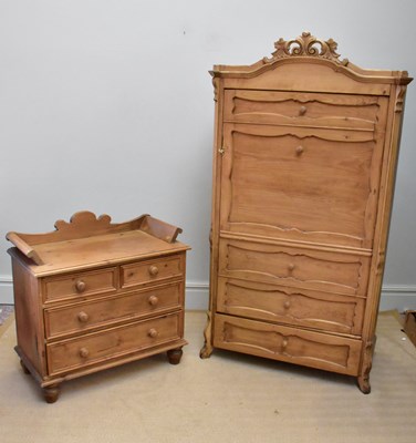 Lot 1376 - A pine wardrobe with four faux drawers and...