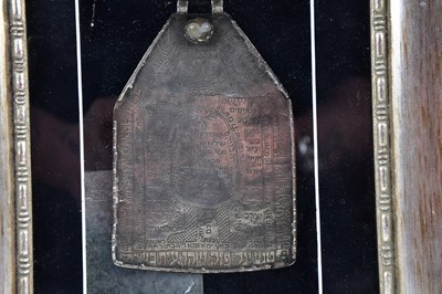 Lot 2238 - A white metal Hebrew plaque, framed and glazed,...