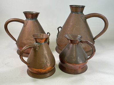 Lot 115 - A set of three graduated copper harvest jugs...