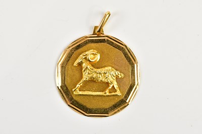 Lot 2457 - A yellow metal pendant, embossed with a ram,...