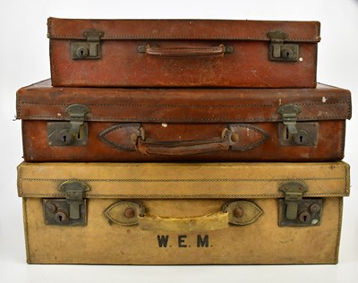 Lot 1554 - Three vintage leather suitcases, one bearing...