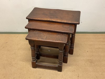 Lot 698 - A nest of three oak tables, tallest height...
