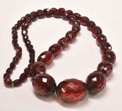 Lot 627 - A vintage cherry amber style graduated facet...