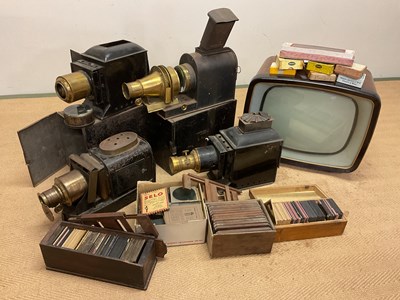 Lot 5 - Four magic lanterns in metal cases with a box...