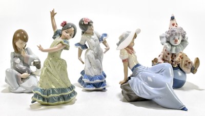 Lot 595 - LLADRO; four ceramic figures comprising boy...