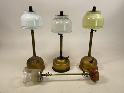 Lot 584 - Three Tilley lamps, one with yellow shade, the...