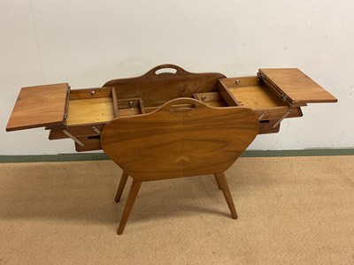 Lot 693 - A mid century sewing table with fold out...