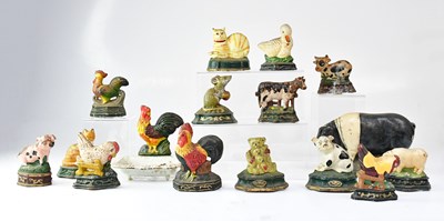 Lot 380 - A collection of cast iron door stops modelled...