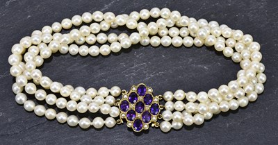 Lot 1325 - A cultured pearl four row choker set with a...