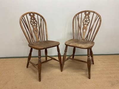 Lot 704 - A pair of elm wheelback dining chairs, height...