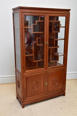 Lot 1183 - A Chinese rosewood display cabinet, with twin...