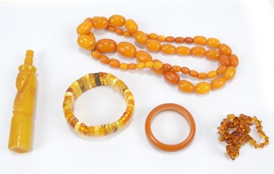 Lot 269 - An egg yolk amber coloured graduated necklace,...