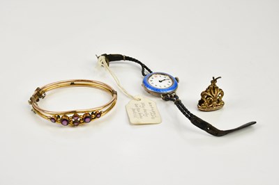 Lot 448 - A yellow metal Victorian amethyst set bangle,...