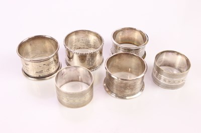 Lot 2206 - Four assorted hallmarked silver napkin rings,...