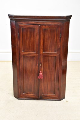 Lot 1393 - A Georgian mahogany hanging corner cupboard...