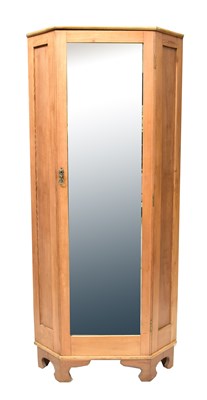 Lot 31 - A pine corner wardrobe with bevelled mirror...