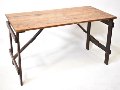 Lot 65 - A vintage oak folding trestle table of plank...